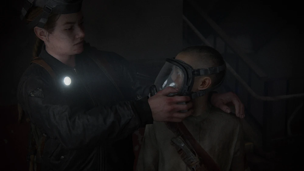 Abby gives Lev the gas mask she just found.